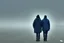 Placeholder: two people seen from behind walking side by side in an empty foggy plain with blue sky above