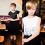 Placeholder: Russian tomboy boyish boylike short man's haircut boyish features in black girlish lacy cocktail dress in restaurant