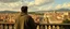 Placeholder: man in a hoodie watching the city from the balcony painted by Caravaggio