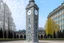 Placeholder: A gray giant and tall clock tower designed in ancient Greek mosaics painted by Rene Magritte