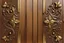 Placeholder: wood panel background with decorative brass corners