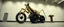 Placeholder: pinhole cam, airbrush 3d rendering, on tv screen:A five-second cinematic single take in a clean industrial presentation hall. A bizarre mechanically plausible tracked atv machine stands beside a presentation podium, designed to look like a giant mechanical praying mantis. Two large bicycle wheels form its main body and four thin articulated mechanical legs support it. Two long folded mechanical front arms resemble mantis forelegs, huge head and arms