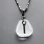 Placeholder: Clear polyester necklace with a chunky silver pendant in the shape of a key