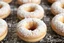 Placeholder: fresh old-fashioned mini doughnuts completely covered in powdered sugar