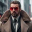 Placeholder: a young man with big muscles who looks like hans gruber wearing a heavy coat and red sunglasses staring with an angry look on his face