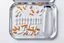 Placeholder: Vaccine ampule on a white table; aluminum tray; pills and packaging material;