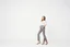 Placeholder: empty simple background and cloudes a beautiful young lady wearing pants and blouse standing gracefully