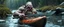 Placeholder: ancient bald fat ogre troll machete in kayak in stream