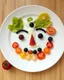 Placeholder: Made a craft a face made by fresh fruits and vegetables toping sauce