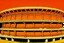 Placeholder: An orange color coliseum with fists painted by Andy Warhol