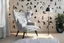 Placeholder: penguin shaped and penguin coloured (black and white) armchair in a modern room, with human feet decorated wallpaper in the background in sunshine