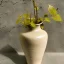 Placeholder: photo of a small cracked ceramic vase repaired with gold, kintsugi, garden setting, beautiful landscape photography, beautiful, vines and leaves, delicate, cinematic, high detail, beautiful composition, delicate arrangement, aesthetic, soft lighting, award winning photography, tender