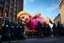 Placeholder: macys thanksgiving day parade style cartoonish giant baby jesus floating parade balloon pulled by multiple grim reapers, multi colored, bright, vivid, psychedelic, high detailed, high gloss, insanely detailed, matte, horrorcore, lining the street, unsettling contrast, monument to death, live action shot grim reaper parade, pulling a jesus parade float