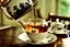 Placeholder: photograph taken (from) an inside perspective (within) a teapot, just above the surface of the tea, with like coming in through the top