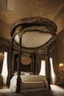 Placeholder: Beautiful ornate four post canopy bed in a dark colored bedroom, victorian, black and gold