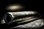 Placeholder: dark image background with rolled newspaper