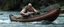 Placeholder: ancient bald fat ogre troll machete sitting relaxed in huge massive kayak in rapid stream, smacking fish with big metal oar