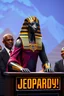 Placeholder: An egypt sphinix host a top show jeopardy tv. Tv set with people. Presidents an celebrities participate in the jeopardy.