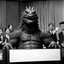 Placeholder: Godzilla gives a press conference.