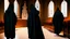 Placeholder: black robe hooded monks in the chapel