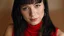 Placeholder: Beautiful caucasian 19 year old girl with shiny black hair. She is wearing a red sleeveless turtleneck. She is smiling shyly at the viewer.