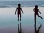 Placeholder: children jumping in water on a beach capture them against the sun and make an art silhouette, hyper details, real sharp, 8k, well detailed, well shaped