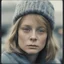 Placeholder: Jodie foster, sad,in the metro in the style of a polaroid, , blue, Grey, beige,orange, with a knitted hat, eyes closed