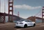 Placeholder: A Tesla 'Model Y' is parked, on the 'Golden Gate' bridge. (CINEMATIC, WIDE ANGLE LENS, PHOTO REAL)