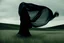 Placeholder: Filmstill Still, abstract object in black fabric in meadow with a liquid floating in breezing wind, in the style of biblical drama, monumental figures, voluminous mass --ar 4:5 --style raw --weird 50