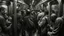 Placeholder: A gritty black and white charcoal drawing of a crowded subway car, filled with diverse passengers going about their daily commute. The scene is chaotic yet intimate, capturing the hustle and bustle of city life. The suffix adds a dream-like quality, with distorted perspectives and exaggerated features of the people