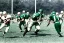 Placeholder: Boston Shamrocks Football team playing against the Toronto Rifles Football team, vintage, hyper-realistic, in color, 1950s football