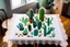 Placeholder: cacti birthday cake on lace tablecloth in a modern kitchen in sunshine