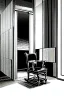 Placeholder: chair in the middle of an empty room, grayscale