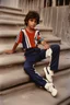 Placeholder: eleven year old mediterranean boy dressed track pants, early 80's color photo