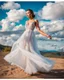 Placeholder: full-body closeup shot of a young, beautiful girl with a perfect face and makeup,wearing pretty dance dress standing in a stage in open air nice hills , blue sky ,pretty clouds at distant