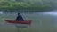 Placeholder: black robed monk in a small boat on quiet water in the mist