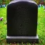 Placeholder: dark flowers grave stone