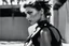Placeholder: [photo by helmut newton in agent provocateur on the arena] Her complexion, after years spent training under the sun, bore the mark of a warrior who had weathered countless battles. Though her face spoke of hardship, there was also an air of grace and serenity that emanated from her every pore. Selene's physique was a testament to her dedication and discipline. Her muscular frame hinted at her physical prowess, yet her movements were fluid, as if she danced with the wind itself.