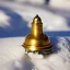 Placeholder: exquisite tiny gold bell half buried in snow, gentle snowy scene, soft lighting