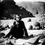 Placeholder: photo, 1920 horror movieshot, sitting, eaging, rocks, very odd objects in background, Ades, stunning photo, persone con sorriso falso e occhi, Charon, tenebroso, macabro, marcio, interno museo, fiotti di liquido nero che zampillano, hypermaximalist, strangeness, sundial light, odd, intricate, Lawrence Alma-Tadema style, albero, hypnotic, very accentuated details of the dress and skin, eerily mysterious, artistic photo, shot on Hasselblad, sadness, follia, smoke, daguerrotype