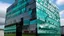 Placeholder: Mirrored steel and smoked glass scales forming a building that appears to shift colors depending on the angle.