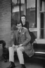 Placeholder: Black and white photo of a serious couple sitting for portrait shoot in the 1930s