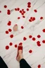 Placeholder: perfect picture of a woman's feet (5 toes) with marble floor as background and red nail polish