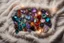 Placeholder: top view of lot of coloured gemstones on fluffy blanket in candlelight