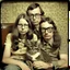 Placeholder: Awkward family portrait Photo with a man and a woman with ugly glasses, 30 years old sitting on chair, serious look, long 1960 hair and mustasch, polaroid camera photo, holding small kittens