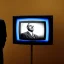 Placeholder: a man in a suit leaning forward on a CRT television screen, cinematic