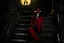 Placeholder: Still frame of Tom Hiddleston as Alucard from the live action "Hellsing" movie based on the anime of the same name. He is wearing his signature red hat and yellow glasses, while laughing in the moonlight.