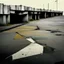 Placeholder: Minimal abstract oil painting in a desolate 1960s carpark concrete fragments and road markings. Broken pipes. Blurry outlines. In the style of Justin Mortimer and Francis Bacon.