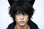 Placeholder: A young man with messy black hair, black cat ears on his head, blue eyes.