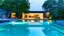 Placeholder: there is a reflection of a tree in the water of a contemporany house pool